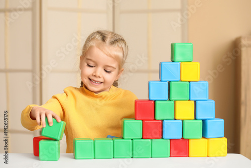 Cute little girl playing wi...