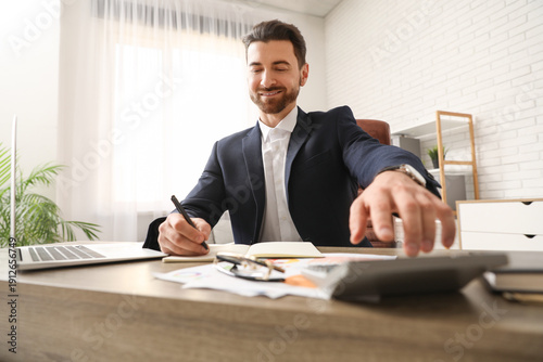 Male accountant doing calcu...
