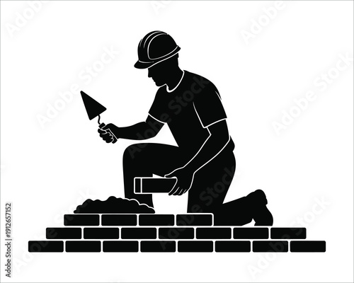 Construction worker building a brick wall