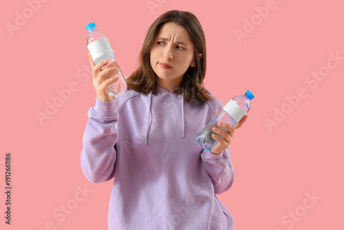 Young woman choosing betwee...