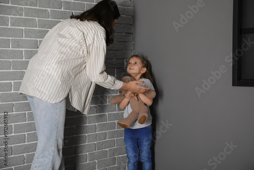 Sad little girl with toy be...