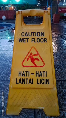 The sign on the board is yellow with the words 