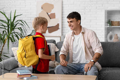Father giving books to his ...
