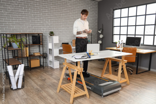 Handsome businessman using ...