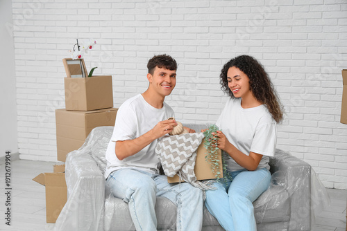 Young happy couple unpackin...