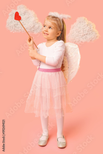 Cute little thoughtful girl dressed as cupid with arrow and clouds on pink background. Valentine's Day celebration