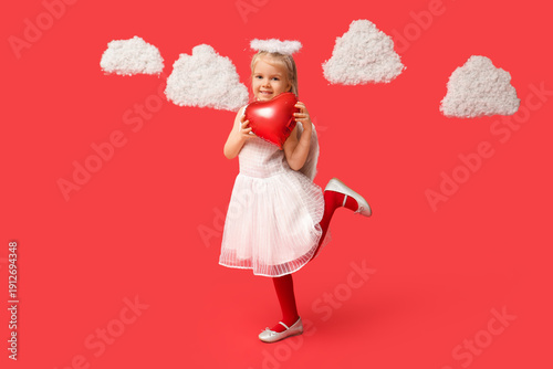 Cute little girl dressed as cupid with heart-shaped balloon and clouds on red background. Valentine's Day celebration