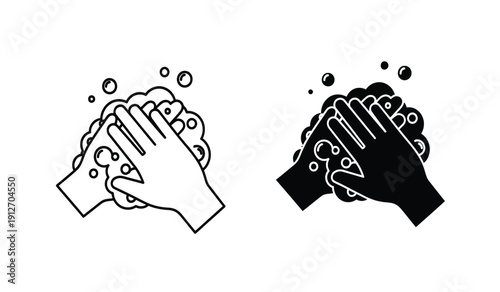 Black and white hands washing with soap bubbles