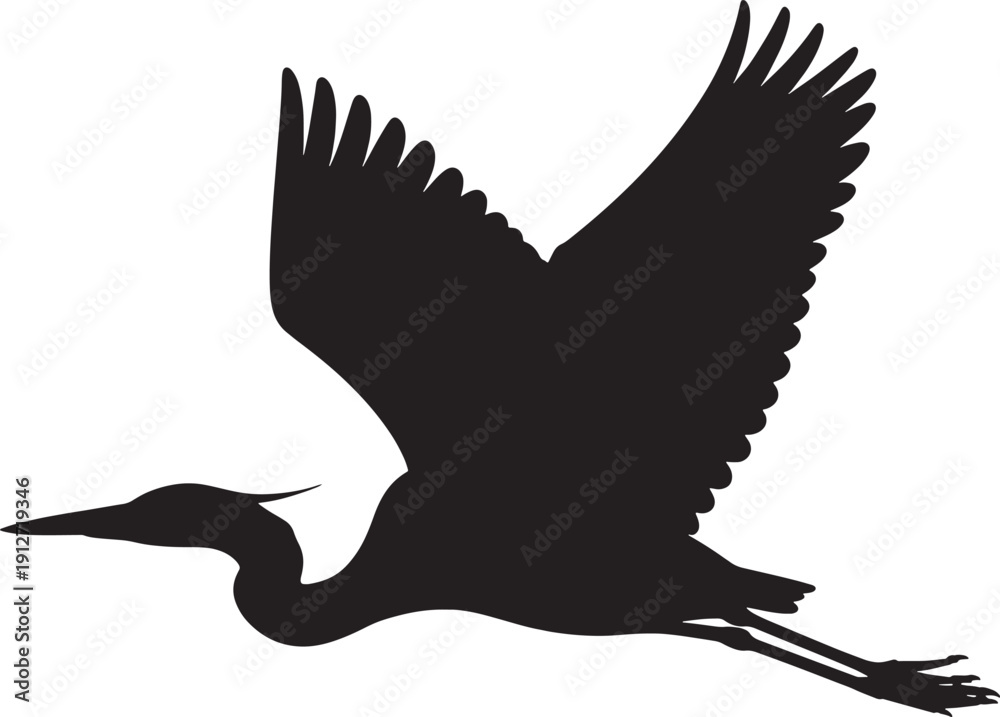 Fototapeta premium Black silhouette of a blue heron in flight with wings spread wide bird flying
