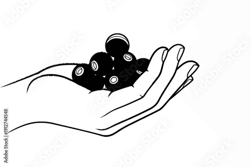 A hand holds a cluster of dark, round objects with white circles