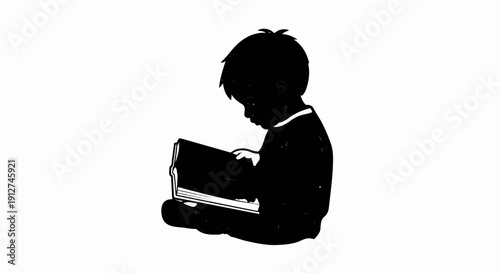 A silhouette of a young child sitting down, intently reading a book
