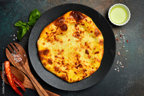 Georgian khachapuri with cheese. Pizza with cheese. On a stone background.