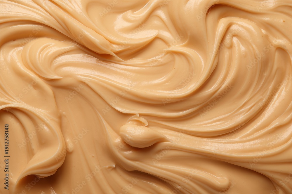 Fototapeta premium Peanut butter swirls creating a delectable creamy texture and background