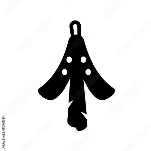 Stylized black bath towel hanging with white polka dots on a white backdrop