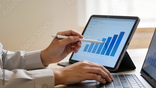 Person analyzing data on tablet
