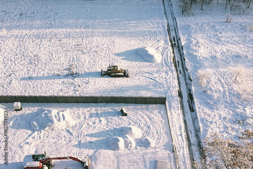 Wallpaper Mural Top view of snow covered field with construction machine Torontodigital.ca