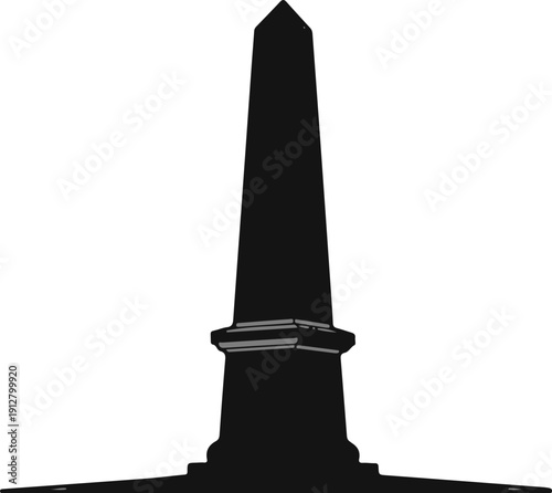 A tall, dark, four-sided monument with a pointed top on a pedestal