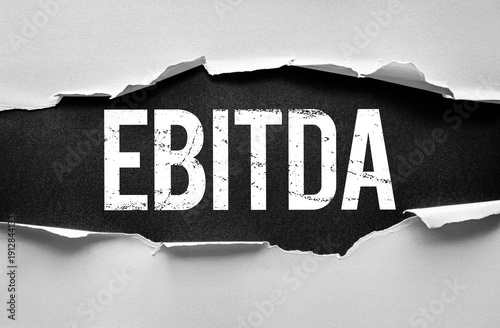 Wallpaper Mural EBITDA text in distressed bold typography under torn paper. Financial and business concept image referring to earnings before interest, taxes, depreciation, and amortization for analysis Torontodigital.ca