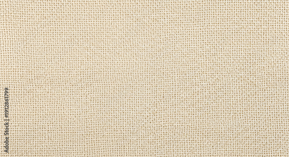 Fototapeta premium A close-up view of a textured beige fabric with subtle woven pattern