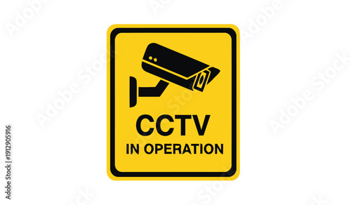A CCTV camera operates in a sign indicating surveillance is active