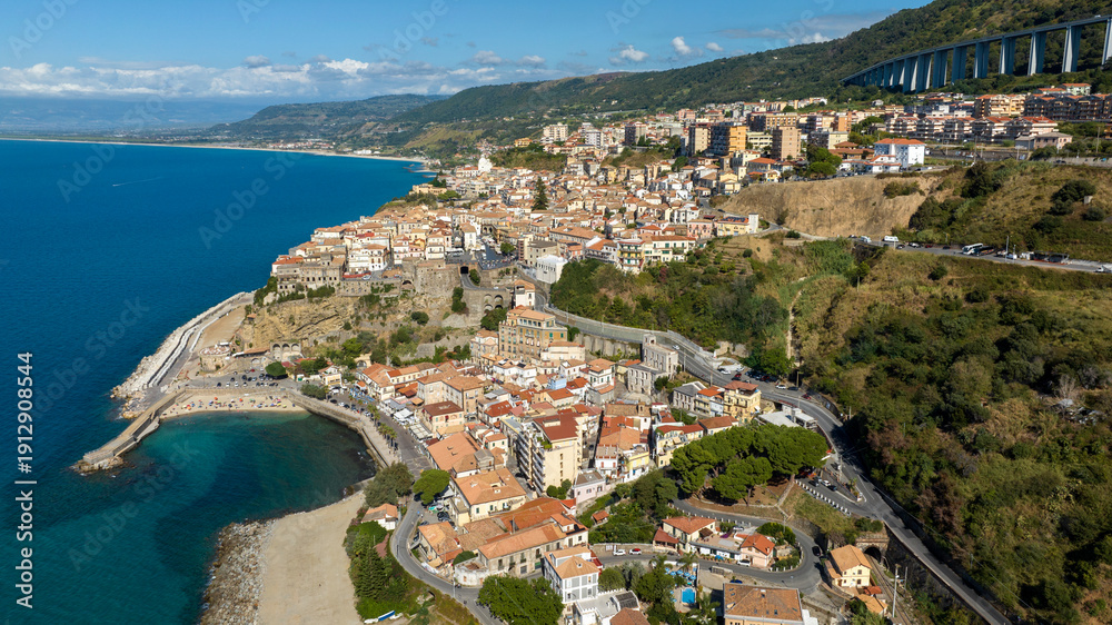 Fototapeta premium Aerial view of the city of Pizzo Calabro, located on the Coast of the Gods, in the province of Vibo Valentia, Calabria, Southern Italy. The town's historic center overlooks the Mediterranean Sea.