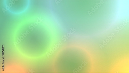 Abstract blurred green background with circular neon colored bokeh.