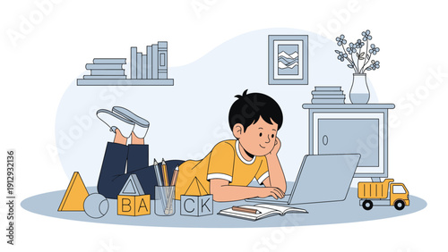 Young boy lying on a rug and using a laptop for online school or entertainment in a cozy playroom filled with books and toys.