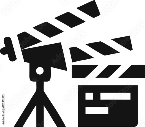 A film camera mounted on a tripod stands next to an open clapperboard ready for filming