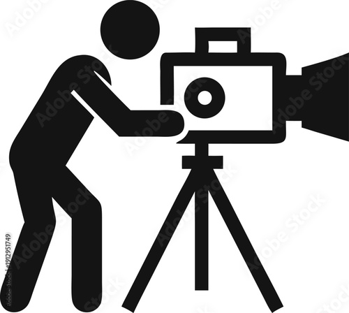 A person professionally operates a large video camera on a sturdy tripod for filming purposes