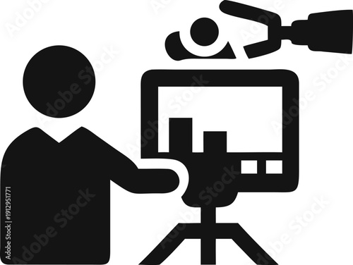 A person operates a video editing station with a monitor displaying footage and graphs