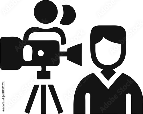 A film crew records an interview with a person using a professional video camera on a tripod