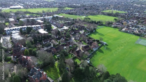 Smooth straight‑line 4K drone flyover showing suburban homes, gardens and tree‑lined streets in Wirral, Merseyside. Ideal for real estate, urban planning, regional development and editorial use across
