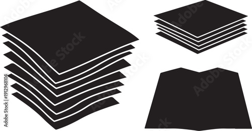 Black paper sheets stacked in different orientations and sizes