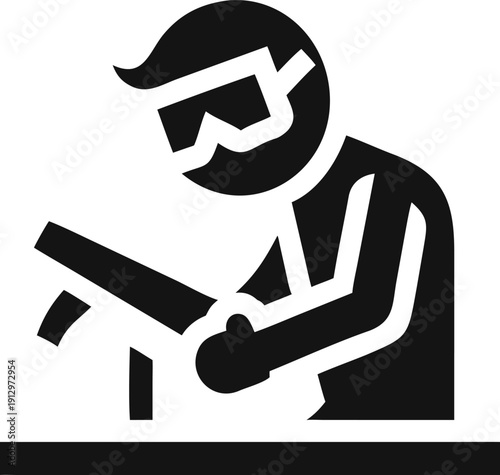 Industrial worker wearing protective glasses operating machinery on a surface