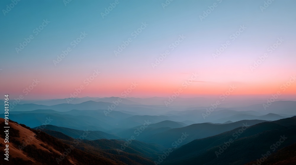 Fototapeta premium Layered mountain range at dusk with a gradient sky transitioning from pink to blue