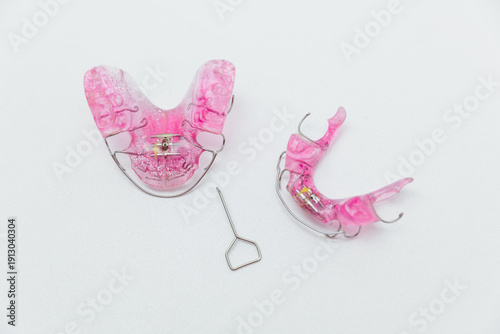 Photos Set of pink removable orthodontic appliances for upper and lower jaw with expans