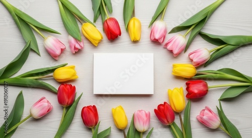 A colorful arrangement of tulips on a white wooden background.