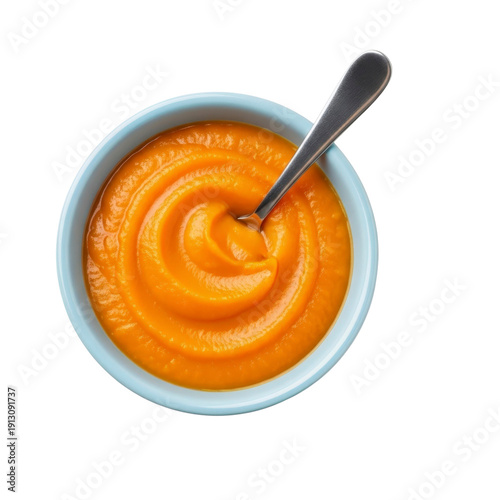 Orange puree in a bowl with a spoon