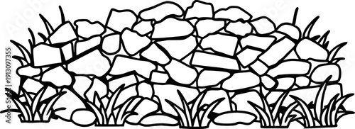 Dry stone wall with scattered grass growing around natural rustic landscape border element