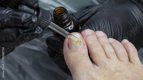 A person is applying nail polish to their toes