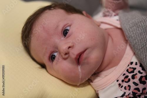 Fotografie Baby spits up after feeding