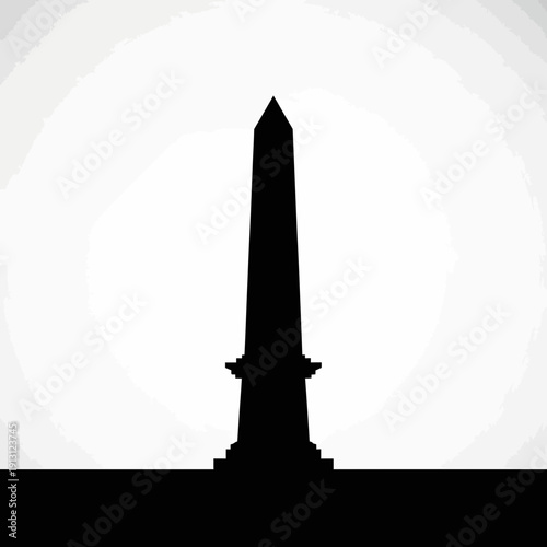 Silhouette of a Tall Obelisk Monument Against a Bright Sky.