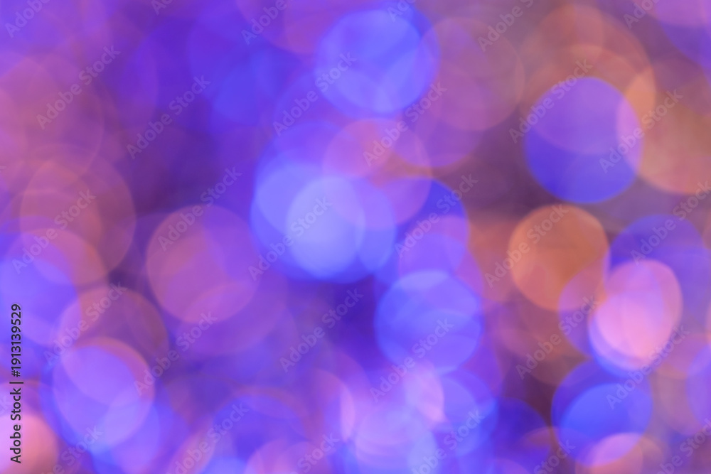 Obraz premium Blurred purple and orange lights creating bokeh background