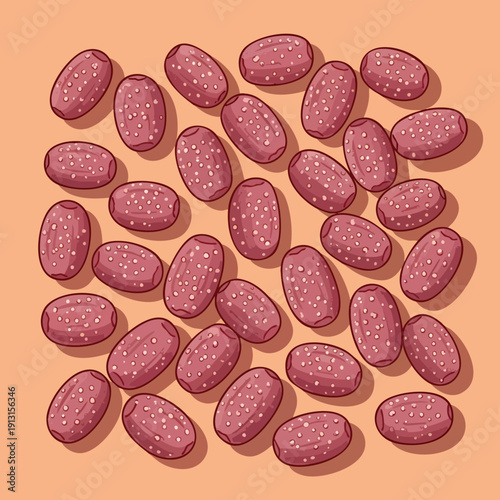 Pink oval beans with white speckles scattered on peach background