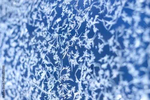 The frost pattern on the glass in winter season, selective focus macro.