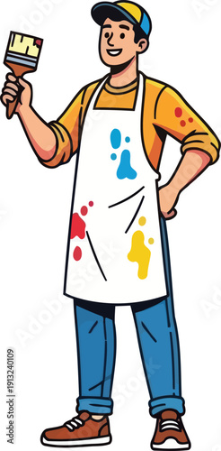 Happy male painter wearing white apron holding paintbrush and smiling in creative studio setting