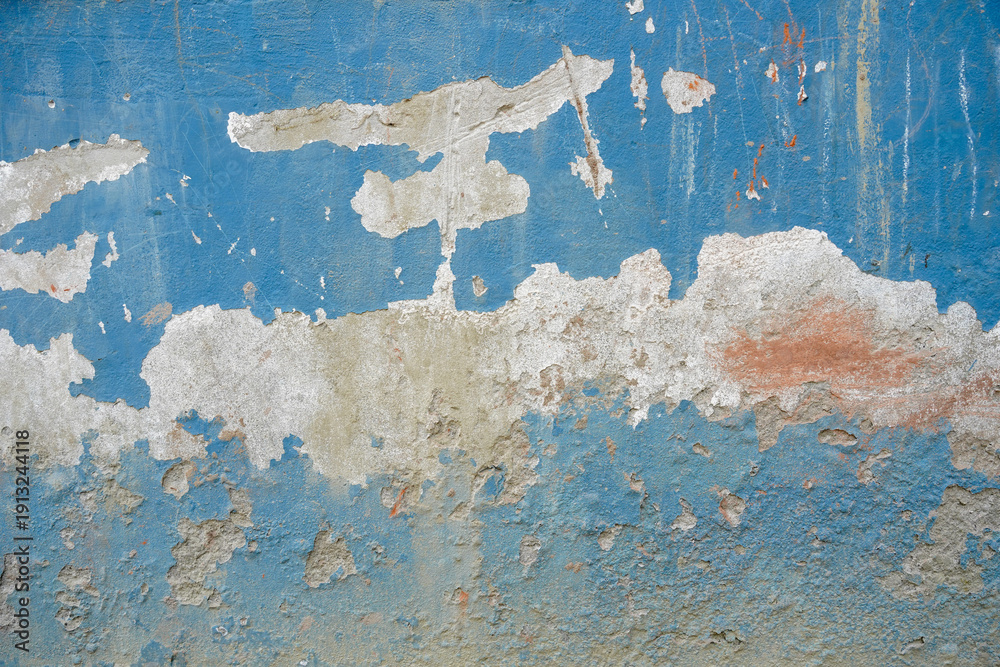 Fototapeta premium peeling blue paint on rough concrete wall texture