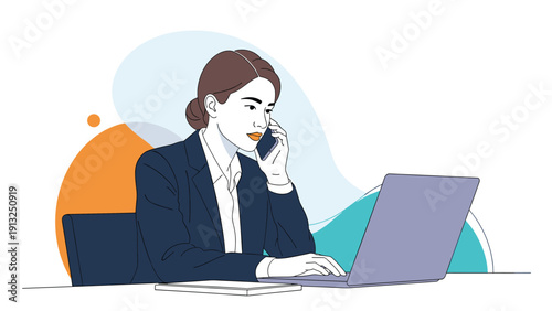 Businesswoman sits at her desk using a laptop computer while talking on a mobile phone to represent multitasking in a professional environment.