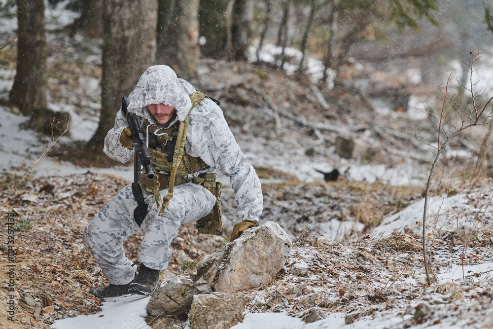 Fototapeta premium Soldier In White Winter Camouflage Patrolling Snowy Forest With Rifle During Cold Weather Operation