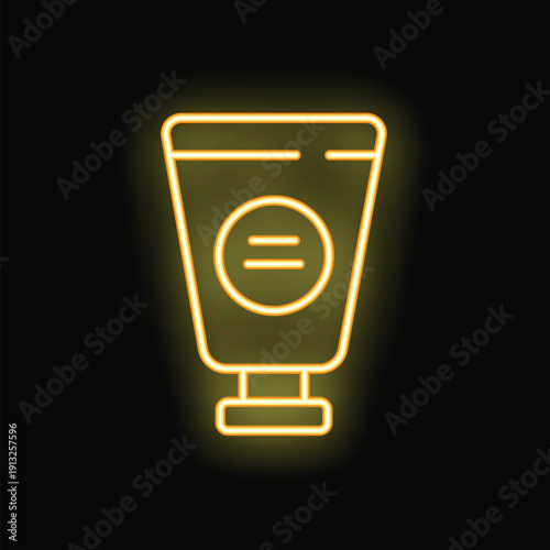 Yellow neon sign in the shape of a cosmetic product tube glowing on a black background